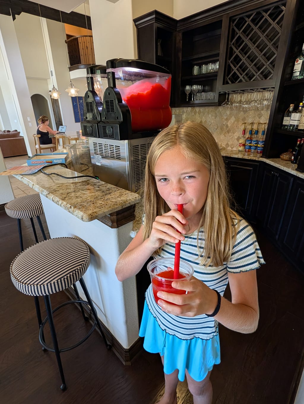 The dual-tank frozen drink machine set up and full of bright red frozen strawberry mix